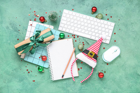 Composition with blank notebook, gadgets and Christmas decorations on color backgroundの写真素材