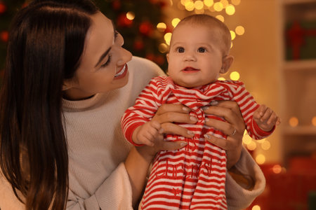Young mother and her little baby at home on Christmas Eve