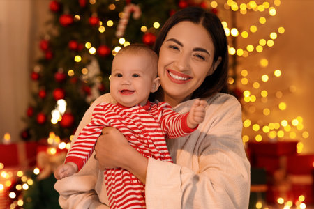 Young mother and her little baby at home on Christmas Eve