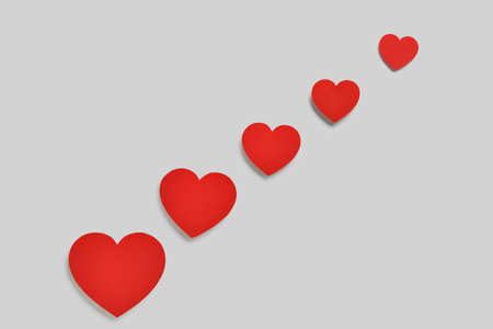 Romantic composition with red paper hearts on white background. St. Valentine's Day.の写真素材