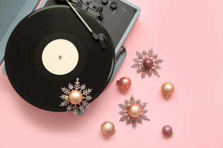 Vintage turntable with Christmas decorations on pink backgroundの写真素材