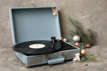 Vintage turntable with Christmas decorations on gray grunge backgroundの写真素材