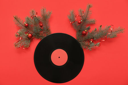Vinyl disc with Christmas decor on red backgroundの写真素材