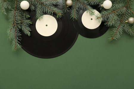 Christmas vinyl records and decorations on green background