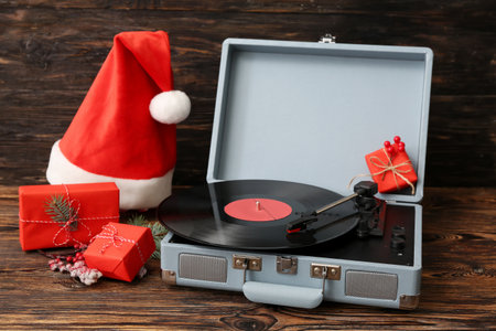 Vintage turntable with vinyl record and Christmas decorations on wooden backgroundの写真素材