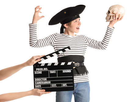 Little actor dressed as pirate and hands with movie clapper on white backgroundの写真素材