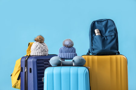 Suitcases with travel accessories on blue backgroundの写真素材