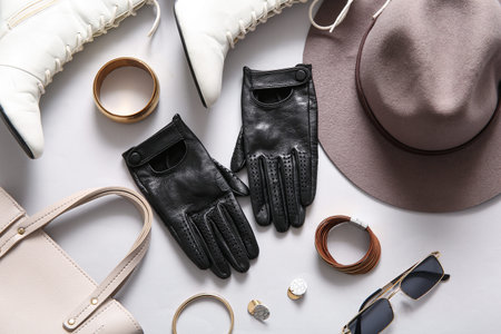 Set of female accessories with black leather gloves on white background