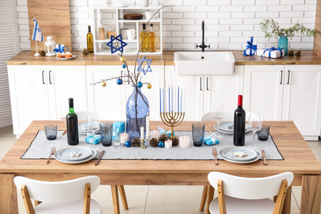 Festive table setting with Hanukkah decorations in kitchenの写真素材