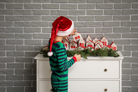 Little boy with Christmas advent calendar at homeの写真素材