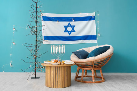 Interior of living room with festive dinner, Israel flag and traditional Hanukkah decorationsの写真素材