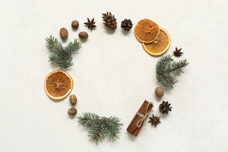 Frame made of fir branches with dried oranges and nuts on white background. Winter solstice conceptの写真素材