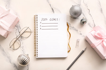 Notebook with empty to do list, eyeglasses and Christmas decor on white grunge backgroundの写真素材