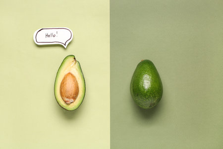 Fresh ripe avocados with speech bubble on green backgroundの写真素材