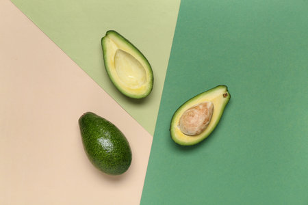 Fresh ripe avocados on colorful background