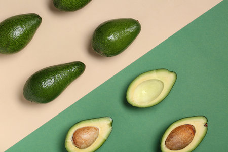 Fresh ripe avocados on colorful background