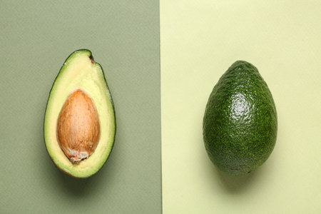 Fresh ripe avocados on green backgroundの写真素材