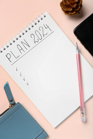 Notebook with empty to do list and pen on pink background