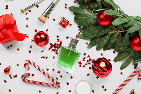 Bottle of perfume with brushes and Christmas decor on white backgroundの写真素材