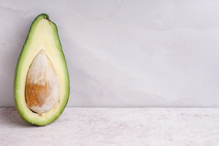 Half of fresh ripe avocado on white background