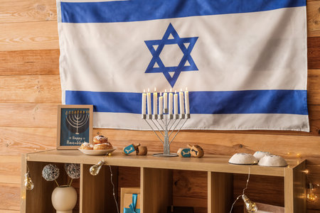 Wooden cabinet with traditional Hanukkah decorations and Israel flag in living roomの写真素材