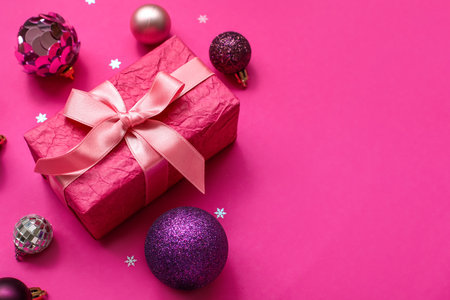 Christmas tree balls with gift on pink backgroundの写真素材