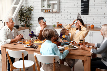 Happy family playing word guessing game at festive table on Thanksgiving Dayの写真素材