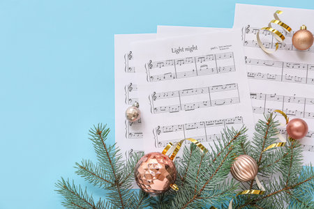 Music note sheets with Christmas decor on blue backgroundの写真素材