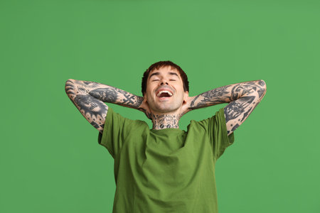 Laughing young man on green backgroundの写真素材