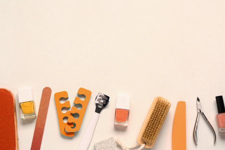 Set of professional tools for pedicure with nail polishes on beige backgroundの写真素材