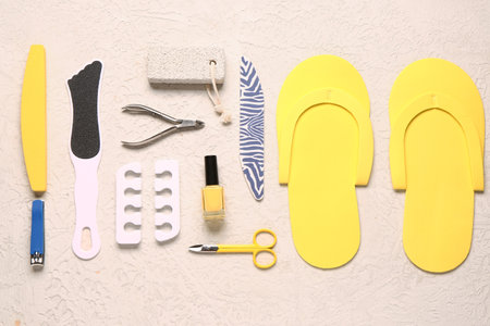 Set of professional tools for pedicure with nail polish on textured white backgroundの写真素材