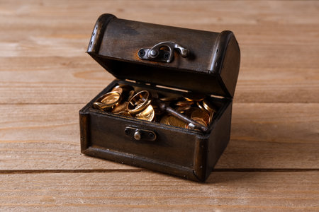 Old chest with treasures on brown wooden backgroundの写真素材