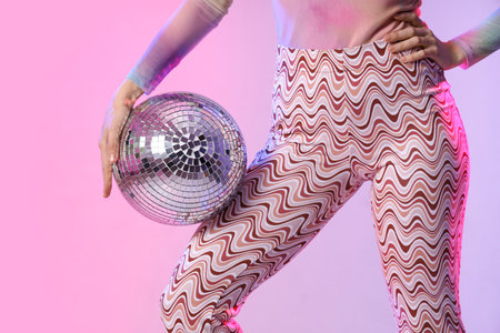 Beautiful young woman with disco ball on color background, closeupの写真素材