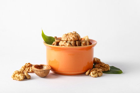 Bowl of tasty walnuts on gray backgroundの写真素材