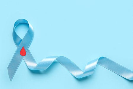 Awareness ribbon with paper blood drop on blue background. Diabetes conceptの写真素材