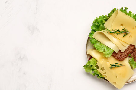 Tasty sandwiches with cheese and lettuce on light backgroundの写真素材