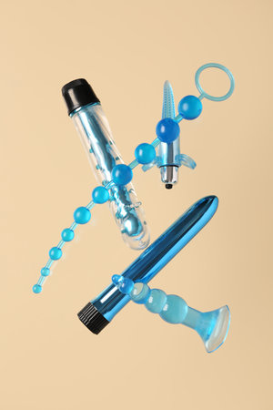 Flying sex toys on beige backgroundの写真素材