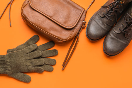 Warm female gloves, handbag and shoes on color backgroundの写真素材