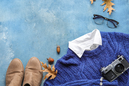 Composition with stylish female clothes, shoes, accessories and autumn decor on color backgroundの写真素材