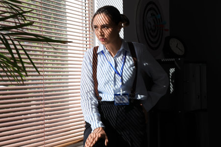 Female FBI agent looking in window at officeの写真素材