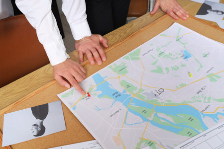FBI agents with map investigating case in office, closeup