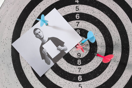 Dartboard with picture of criminal and bullseye in FBI office, closeupの写真素材