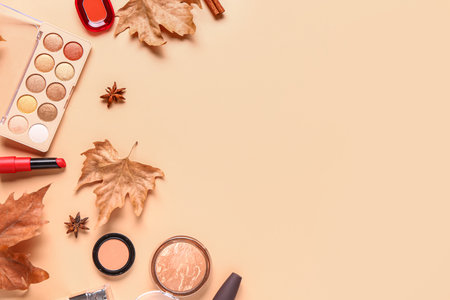 Composition with cosmetic products and autumn leaves on beige backgroundの写真素材