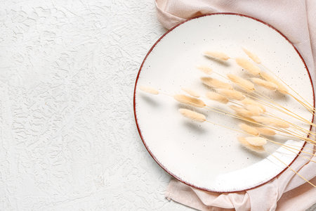 Stylish autumn table setting with dried lagurus on white backgroundの写真素材