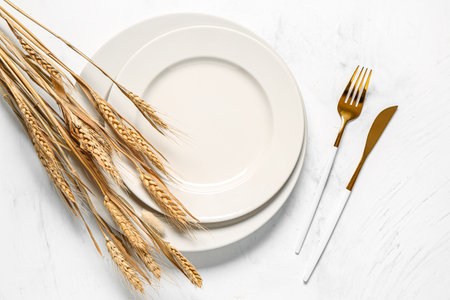 Stylish autumn table setting with ears of wheat on white backgroundの写真素材