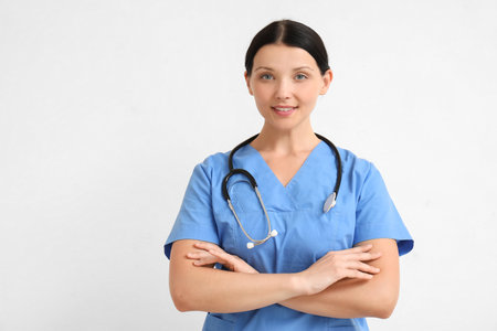 Female doctor on light backgroundの写真素材