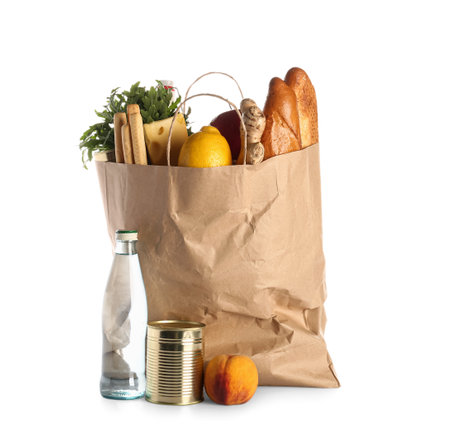 Paper bag full of food and bottle of water on white backgroundの写真素材