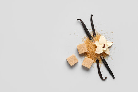 Aromatic vanilla sugar, flower and sticks on gray backgroundの写真素材