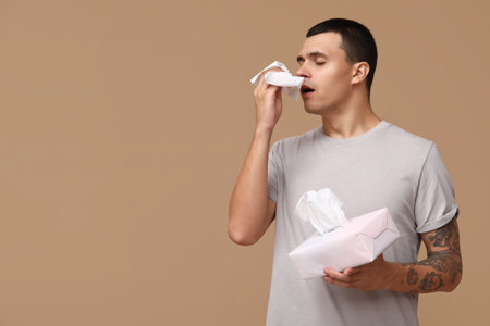 Ill young man on brown backgroundの写真素材