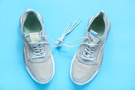 Stylish blue sneakers on color backgroundの写真素材